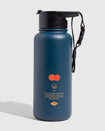 Lake - Waves Bottle - 23 Oz. Insulated Stainless Steel (Angle): Navy blue insulated bottle with orange graphic, black cap and wrist strap