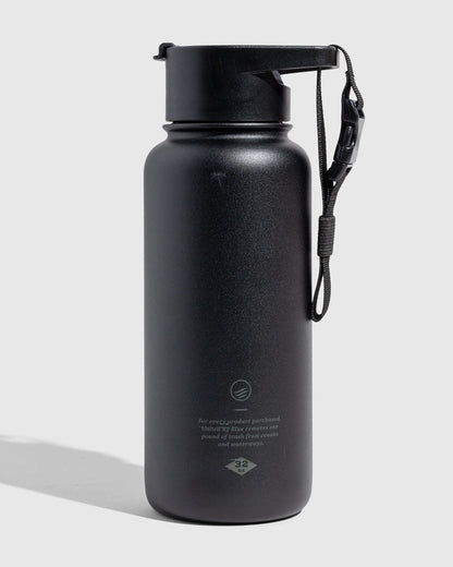 Black - Ink Bottle - 23 Oz. Insulated Stainless Steel (Angle): Matte black insulated bottle with flip-top lid and wrist strap attached