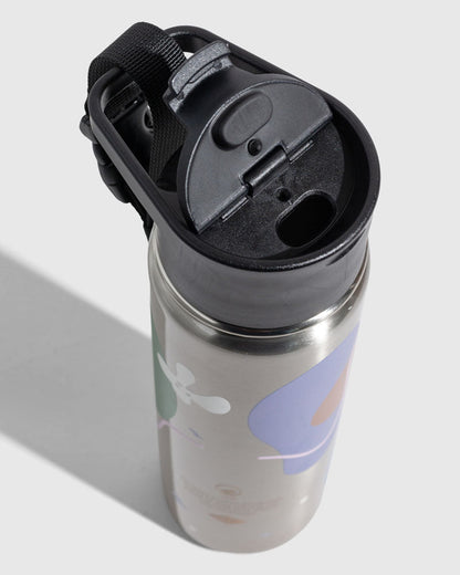 Illuminate Bottle - 23 Oz. Insulated Stainless Steel (Detail): Top-down view of black flip-top lid with carry strap and stainless body featuring colorful abstract shapes