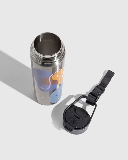 Illuminate Insulated Steel Bottle 32 Oz. (Angle): Open stainless bottle with abstract purple, orange, blue shapes; black lid beside