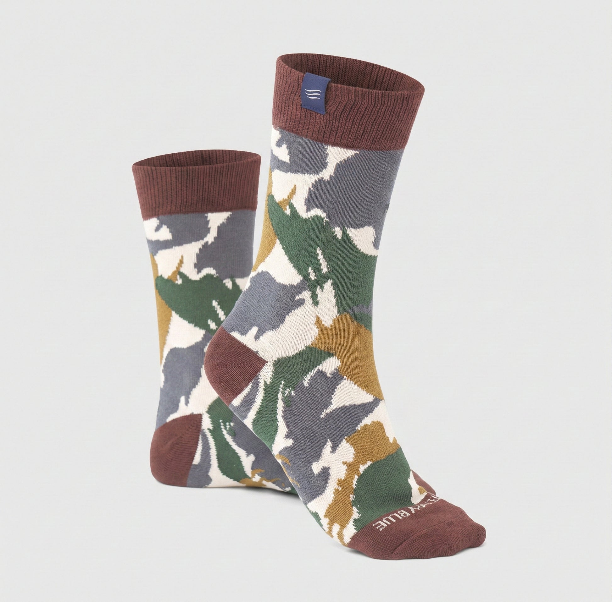 Mahogany IMPACT COLLECTION - Hemp Blend Socks (Angle): Crew socks with camouflage print in gray, green, gold, and white, dark red cuffs, heel, and toe