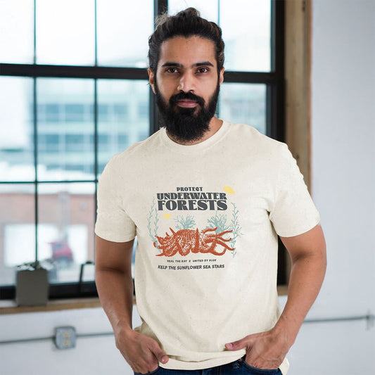 S Heal the Bay x UBB Protect Our Underwater Forests - Graphic Tee - (All-gender) (In-use): Bearded man wearing cream tee with ocean conservation graphic print indoors