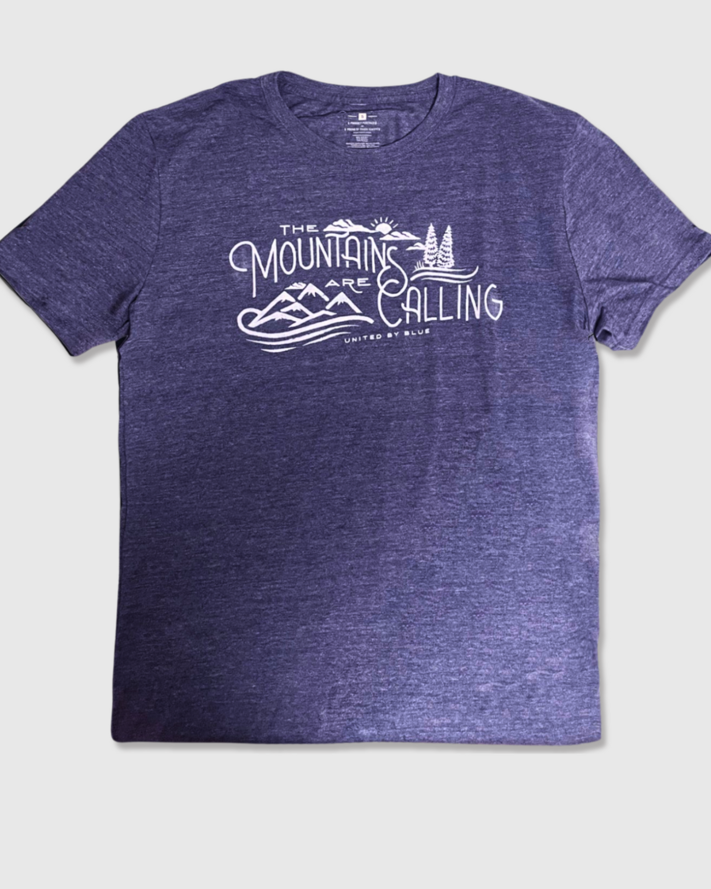 Heathered Navy Mountains Are Calling - Biodegradable Graphic Tee - (All-gender) (Flat-lay): Purple heathered crew neck tee with white mountain landscape graphic print