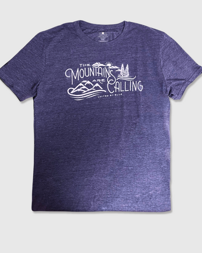 Heathered Navy Mountains Are Calling - Biodegradable Graphic Tee - (All-gender) (Flat-lay): Purple heathered crew neck tee with white mountain landscape graphic print