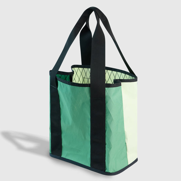 Evergreen The Westward Tote (Angle): Open green color-block tote with dark straps and argyle-print interior
