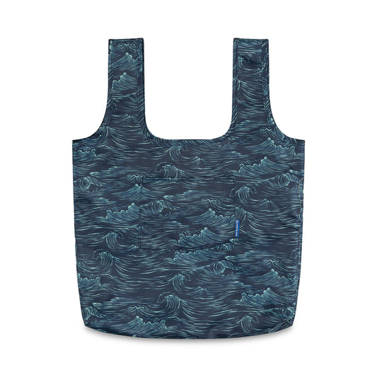Waves The Packable Tote (Front): Navy packable tote with white ocean wave print, two long straps, and front patch pocket