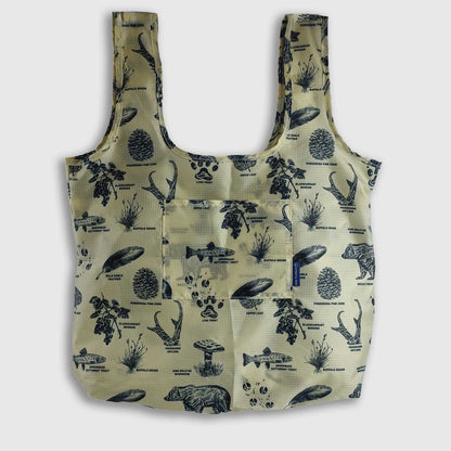 Grizzly The Packable Tote (Front): Tan tote with navy nature print, two straps, front pocket