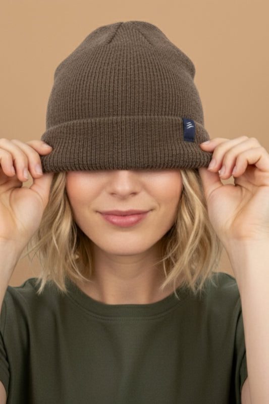 Taupe Classic Yak Beanie (In-use): Smiling woman pulls taupe ribbed knit beanie down over her eyes