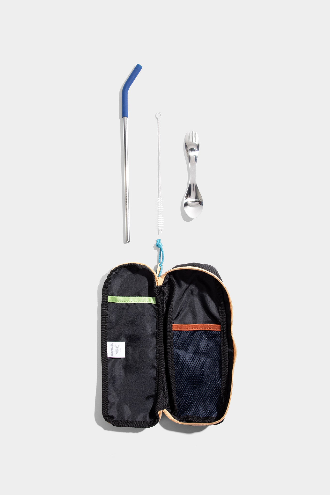 Black The Utensil Pack - Perfect for Packed Lunches (Flat-lay): Open black case with mesh pocket beside reusable straw and spork utensil
