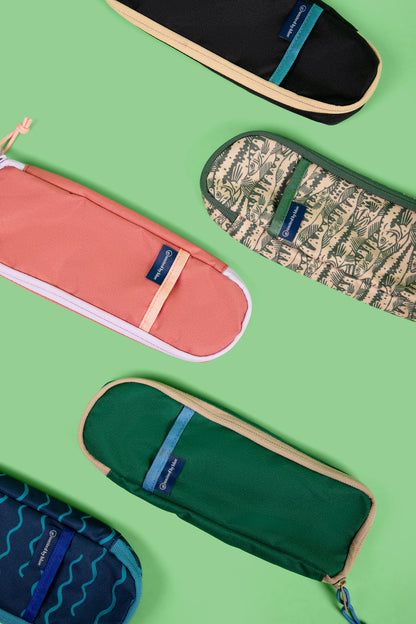 The Utensil Pack - Perfect for Packed Lunches (Flat-lay): Five zippered pouches in black, coral, green, tan print, and blue wave patterns