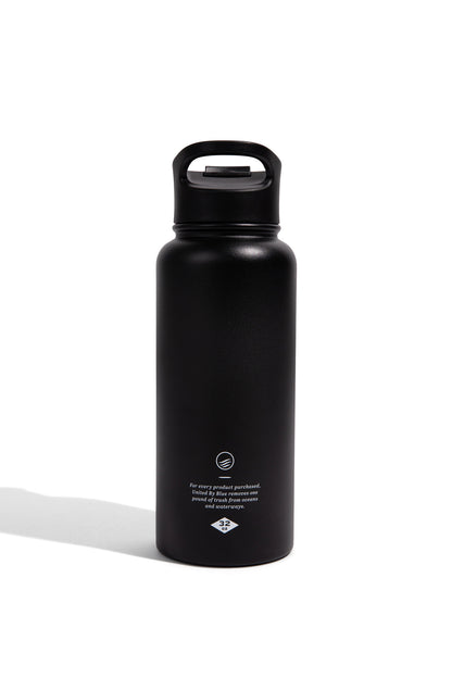 Black - Ink Bottle - 23 Oz. Insulated Stainless Steel (Back): Matte black insulated bottle with loop lid and ocean cleanup branding