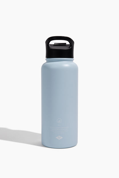 Eggshell - Reuse Bottle - 23 Oz. Insulated Stainless Steel (Back): Light blue insulated steel bottle with black carry-handle lid, small back logo