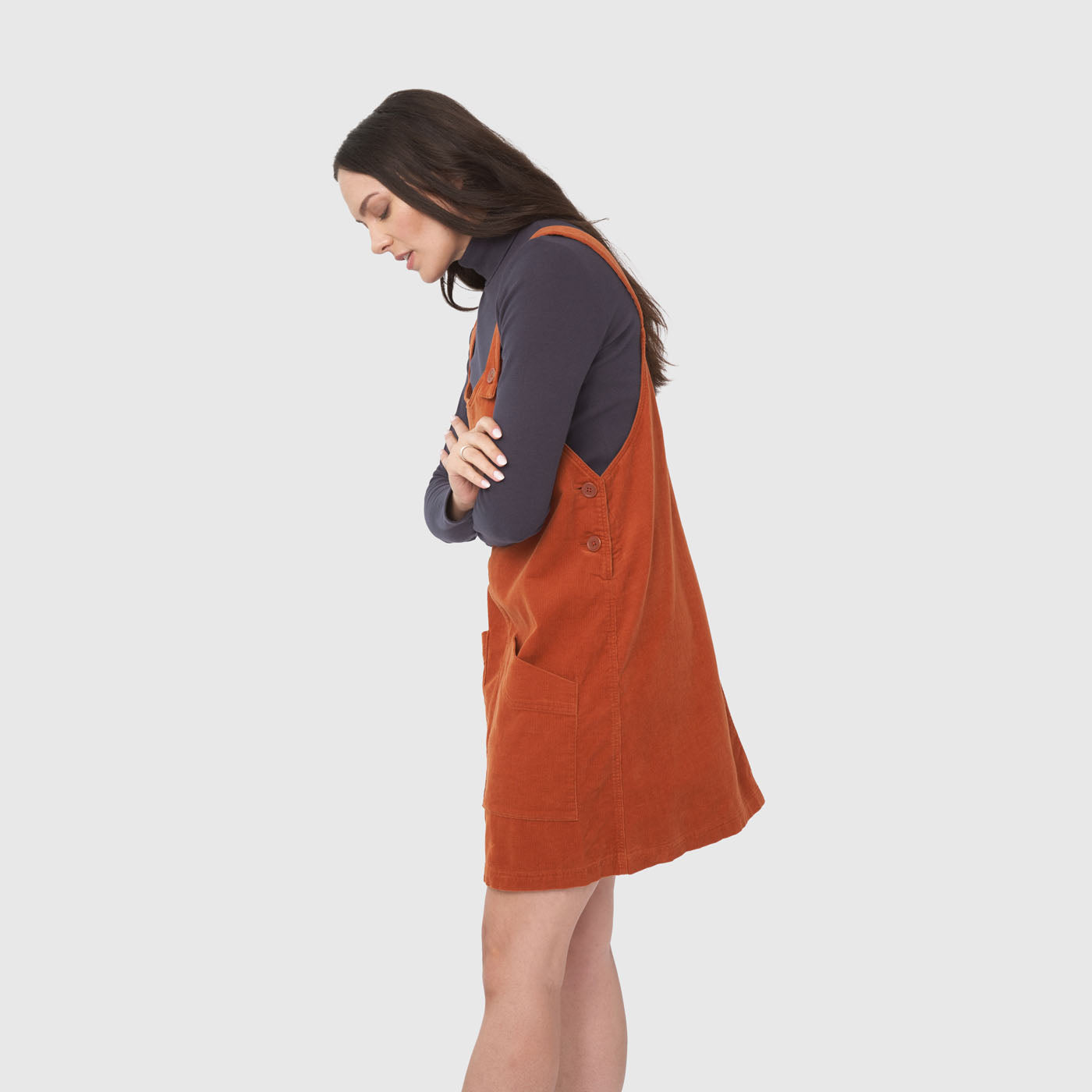 Ginger Corduroy Overall Dress (Side): Rust-orange corduroy pinafore with shoulder straps, side buttons, and patch pocket