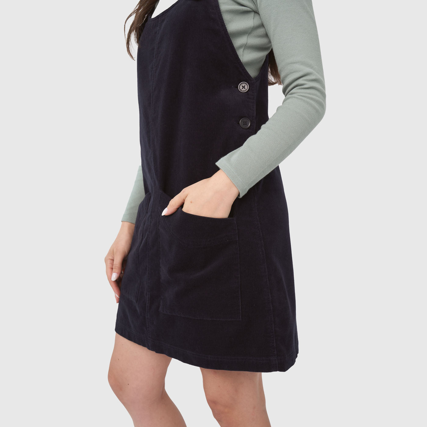 Night Sky Corduroy Overall Dress (Angle): Dark navy corduroy pinafore dress with front pocket and side buttons