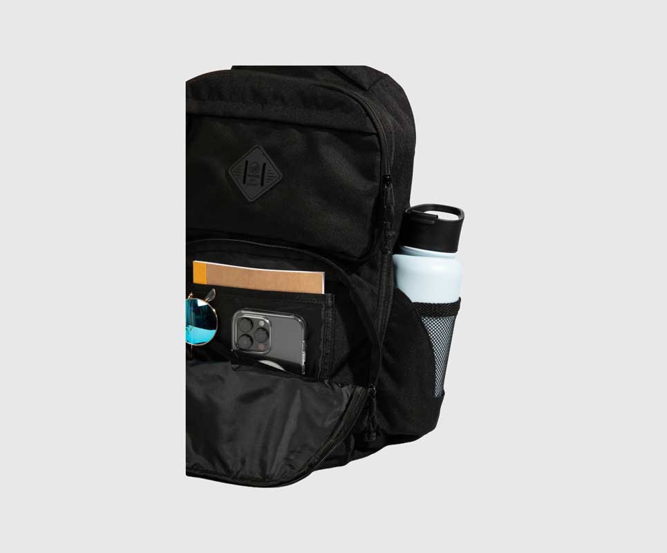 Black (R)evolution™ 25L Transit Pack (Detail): Open front pocket reveals phone, sunglasses, notebook, and side water bottle pocket