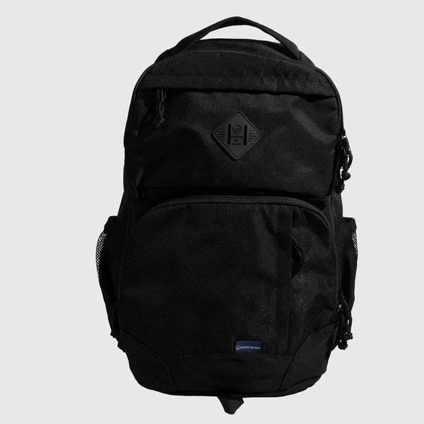 Black (R)evolution™ 25L Transit Pack (Front): All-black backpack with diamond logo patch, front pocket, mesh side pockets