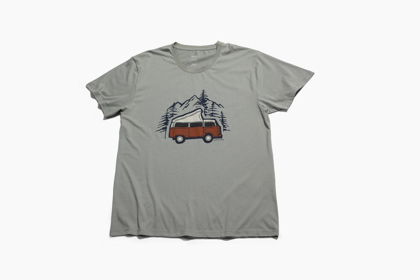LIMESTONE Adventure Van Graphic Crew (Flat-lay): Sage green tee with rust-colored retro camper van, pine trees, mountains graphic