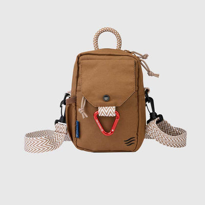 Tigers Eye (R)evolution™ Daily Cross Body (Front): Tan canvas crossbody bag with chevron strap, red carabiner, and rope handle