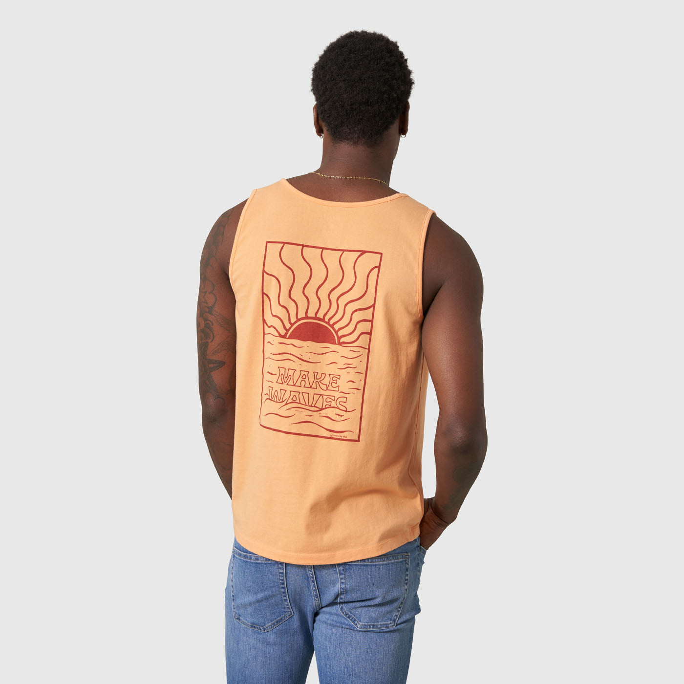 Make Waves Papaya Graphic Tank (Back): Peach sleeveless tank, back graphic of sun and waves, text reads Make Waves