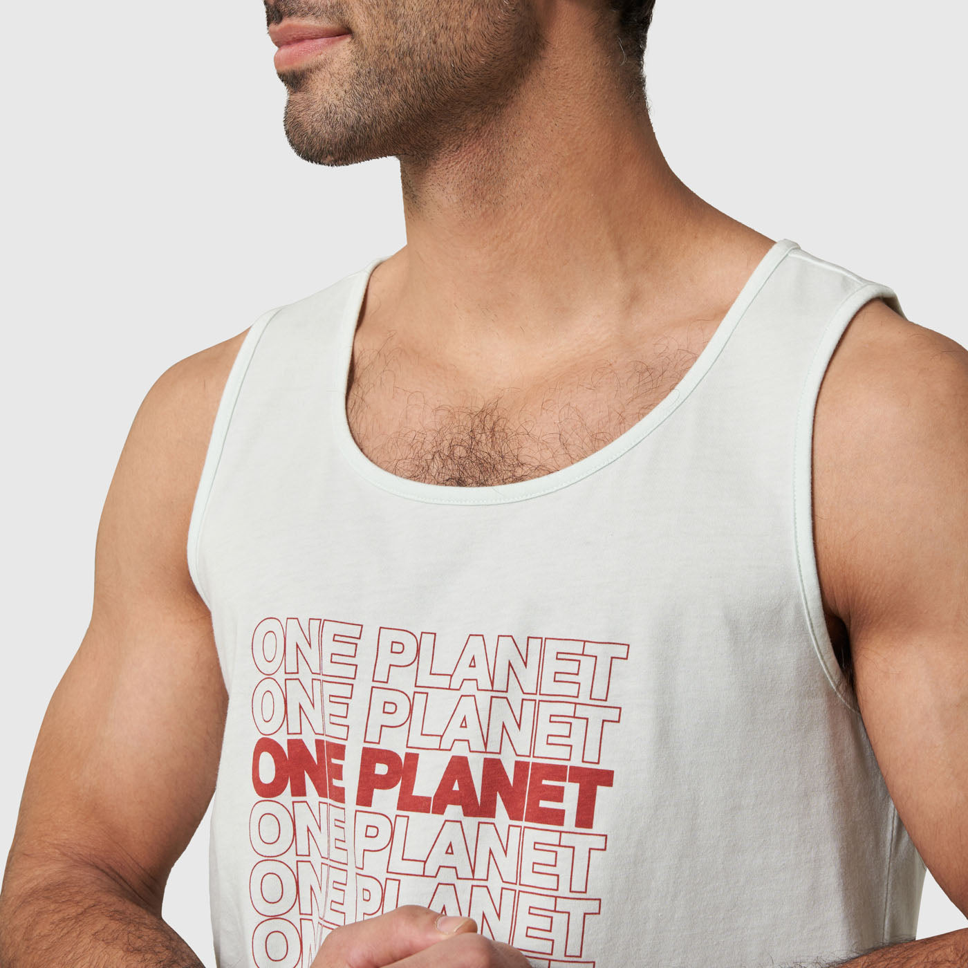One Planet Light Aqua Graphic Tank (Detail): Light aqua sleeveless tank with repeated red ONE PLANET chest print