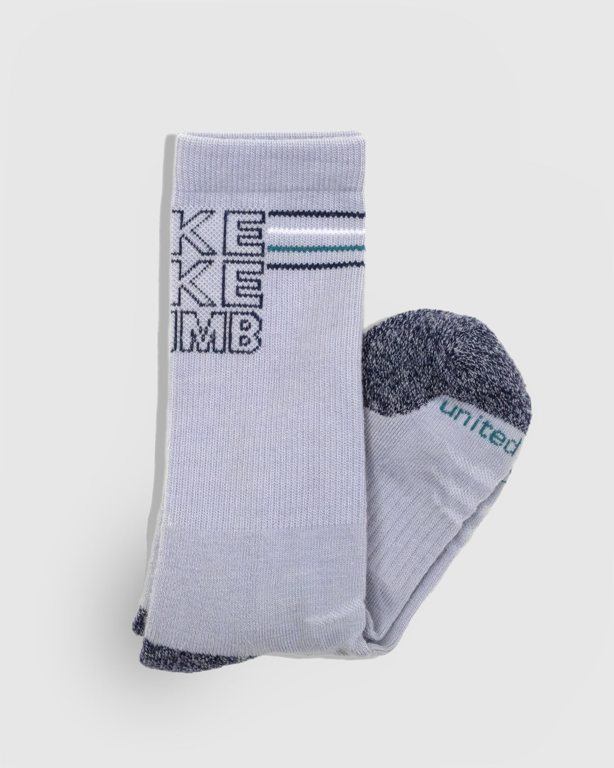 HikeBikeClimb - Periwinkle Merino Wool - Graphic Crew Sock (Detail): Folded periwinkle crew sock showing knit text and marled navy toe