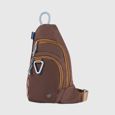 Brown (R)evolution Sling Pack (Angle): Chocolate brown sling pack with tan zippers, carabiner, and rope loop handle