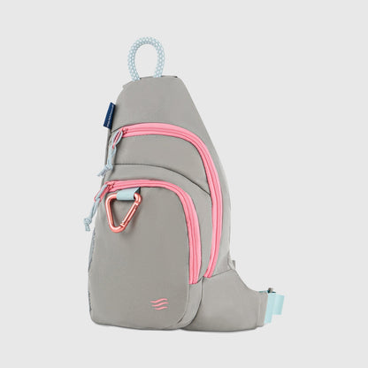 Lt Gray (R)evolution Sling Pack (Front): Light gray sling pack with bright pink zippers, pink carabiner clip, and blue rope handle