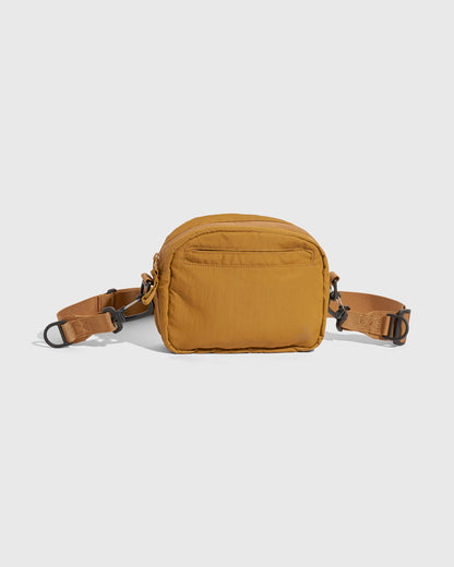 Smoky Ochre (Re)active™ 2L Convertible Crossbody (Back): Golden yellow crossbody bag with back zip pocket and adjustable strap