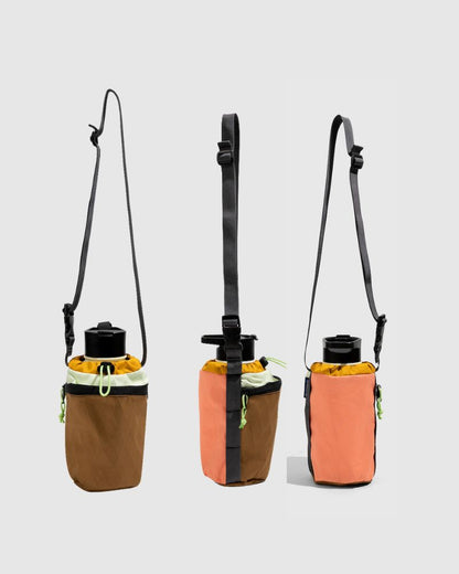 Water Bottle Sling - Westward (Pre-Release) (Front): Three bottle slings in brown, coral, and navy with black crossbody straps