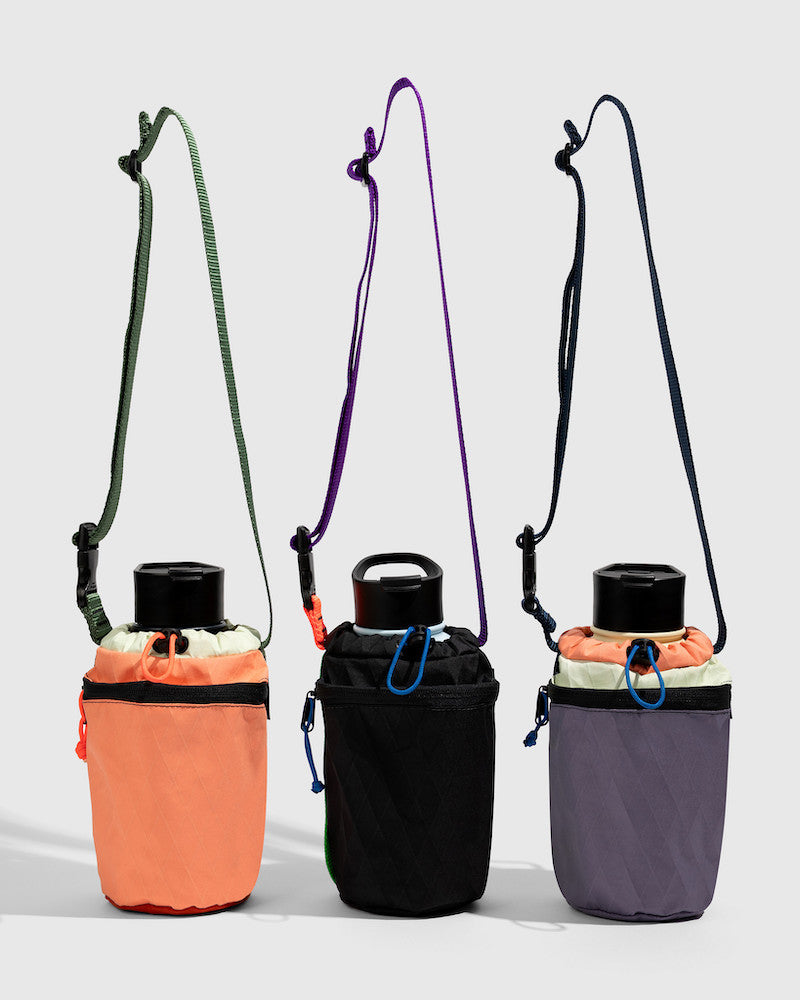 Water Bottle Sling - Westward (Pre-Release) (Front): Three water bottle slings in coral, black, and purple with crossbody straps
