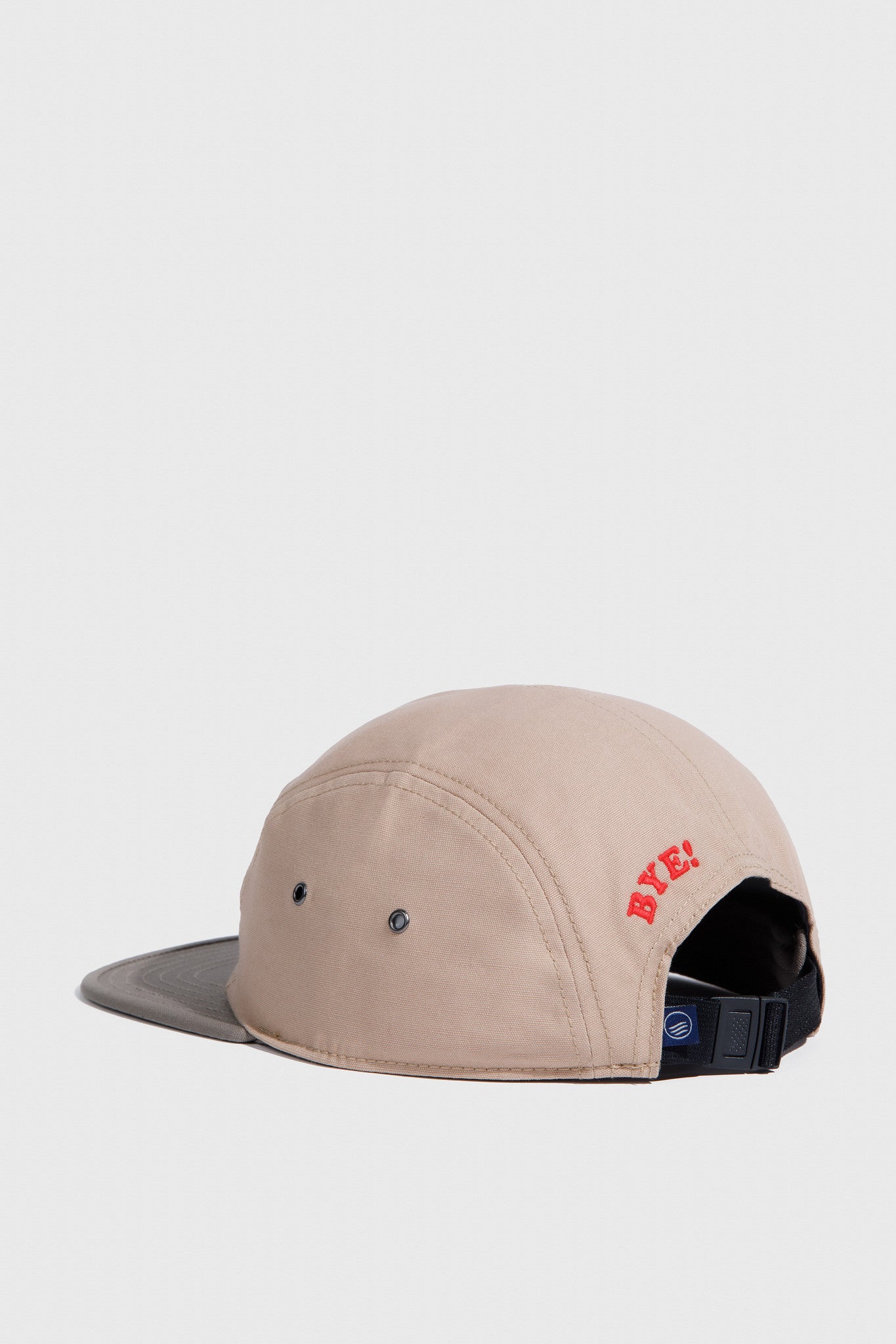Tan Hi Organic 5-Panel Hat (Angle): Tan five-panel cap with dark brim, red BYE! embroidery, black buckle strap