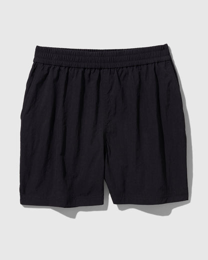 Black Recycled Sport Short (Flat-lay): Black elastic-waist shorts with side pockets and slightly crinkled fabric
