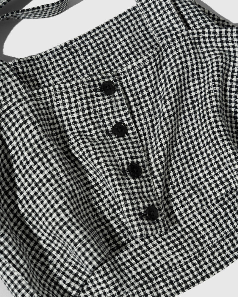 Black Linen Cropped Tank (Detail): Close-up of black and white gingham fabric with four black buttons
