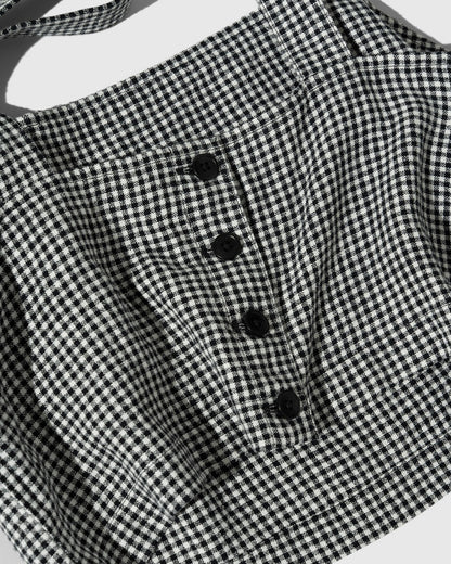 Black Linen Cropped Tank (Detail): Close-up of black and white gingham fabric with four black buttons