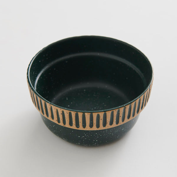 Pine Stoneware Stackable Bowl (Angle): Dark green speckled bowl with tan carved stripe pattern around exterior