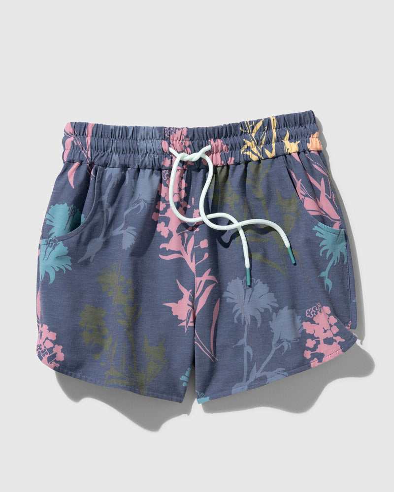 Midnight The Responsible Swim Short (Flat-lay): Dark blue floral shorts with pink teal motifs, white drawstring, side pockets