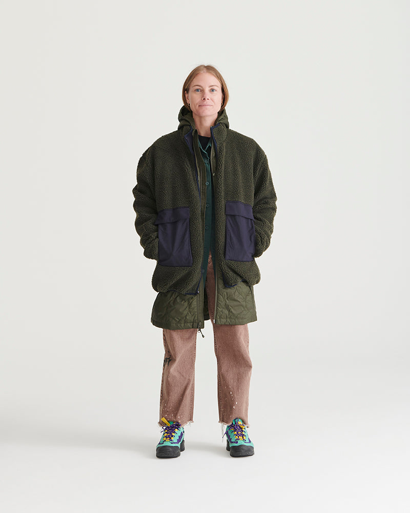 Forest Floor Bison Ultralight Long Liner Jacket (In-use): Woman wearing dark olive sherpa zip jacket with navy front pockets
