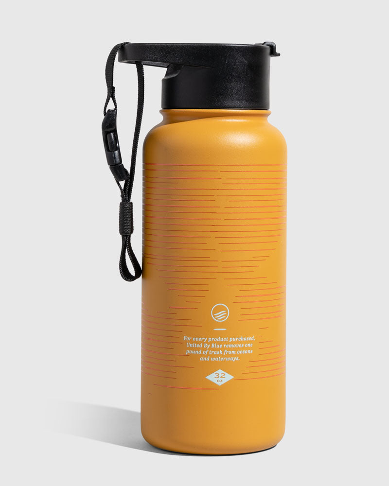 Insulated Steel Bottle 32 Oz. (Angle): Mustard yellow bottle with red striped pattern, black lid and strap
