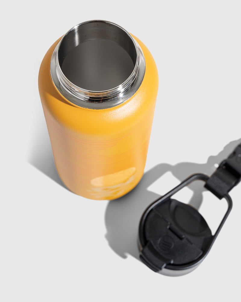 Insulated Steel Bottle 32 Oz. (Detail): Yellow stainless steel bottle open top with black cap beside it