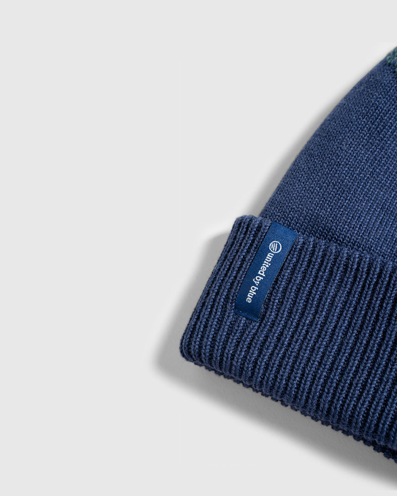 NAVY Recycled Chevron Pom Beanie (Detail): Close-up of folded ribbed cuff with small United by Blue label