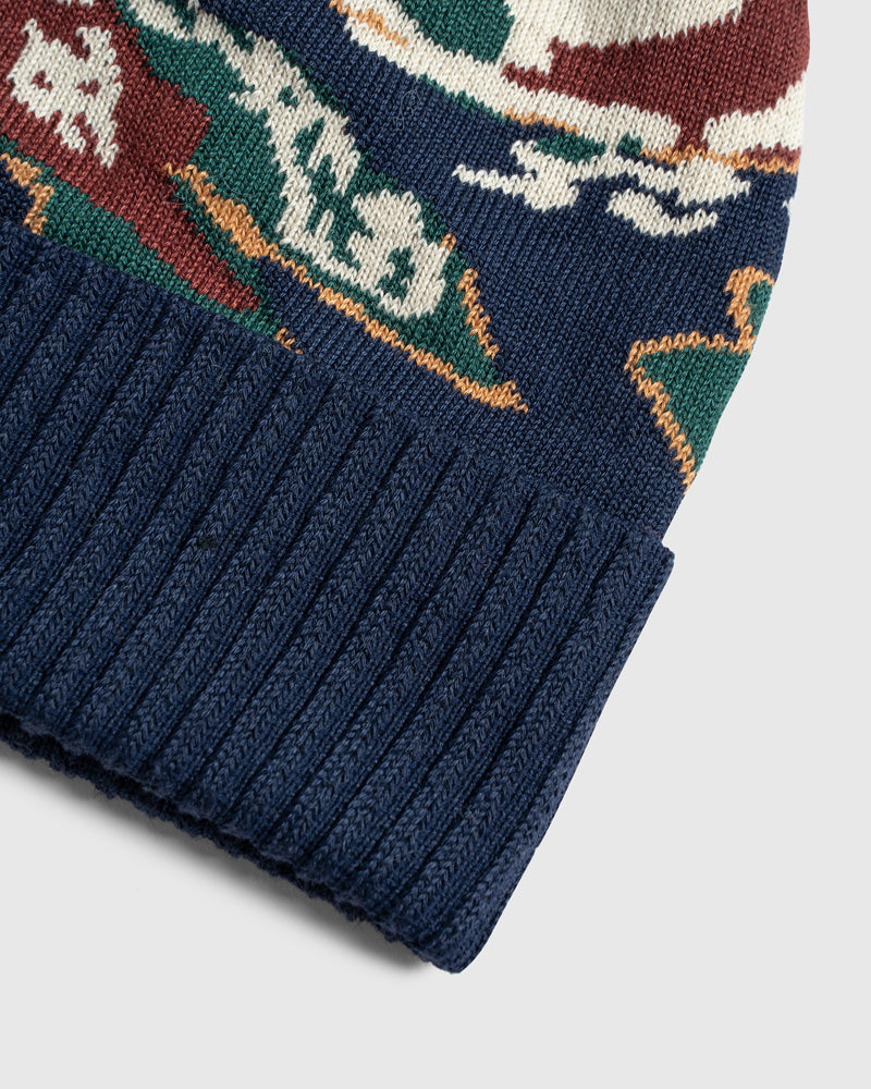 Lakeside Camo Recycled Novelty Pom Beanie (Detail): Close-up of navy ribbed cuff with multicolor intarsia knit pattern above