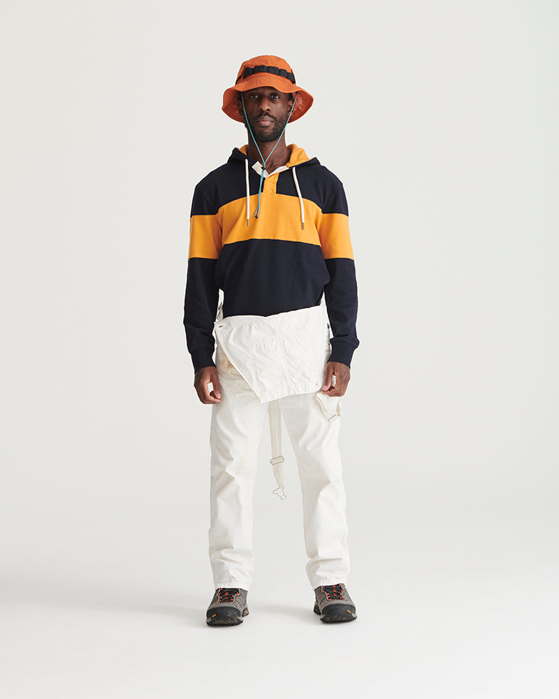 Tangerine Organic Bucket Stash Hat (In-use): Man wearing orange bucket hat with dark stripe and chin cord