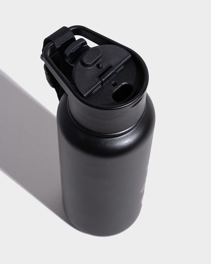 Ebony Insulated Steel Bottle 32 Oz. (Detail): Close-up of black insulated bottle showing flip-top lid with carry strap