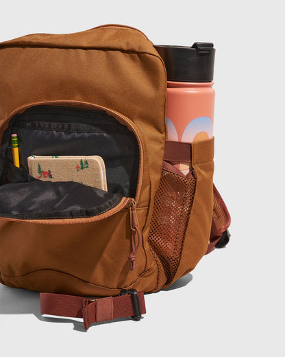 Camel (R)evolution™ 9L Sidekick (Detail): Open front pocket reveals pencil and notebook beside a coral water bottle