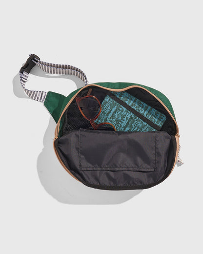 Pine (R)evolution™ 3L Utility Fanny Pack (Detail): Open green fanny pack interior showing sunglasses, patterned lining, and organizer pockets