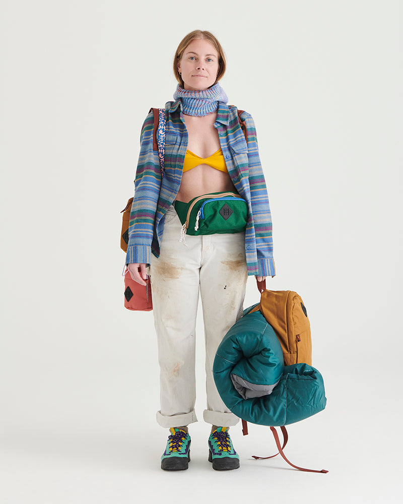 Pine (R)evolution™ 3L Utility Fanny Pack (In-use): Green fanny pack worn at waist by woman in striped flannel shirt