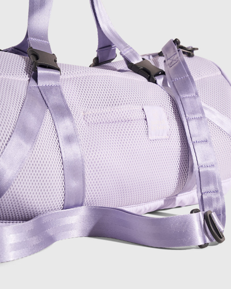 Lavender (Re)active™ 16L Mini Duffle (Detail): Light purple mesh exterior with buckle straps, D-ring, and small patch label