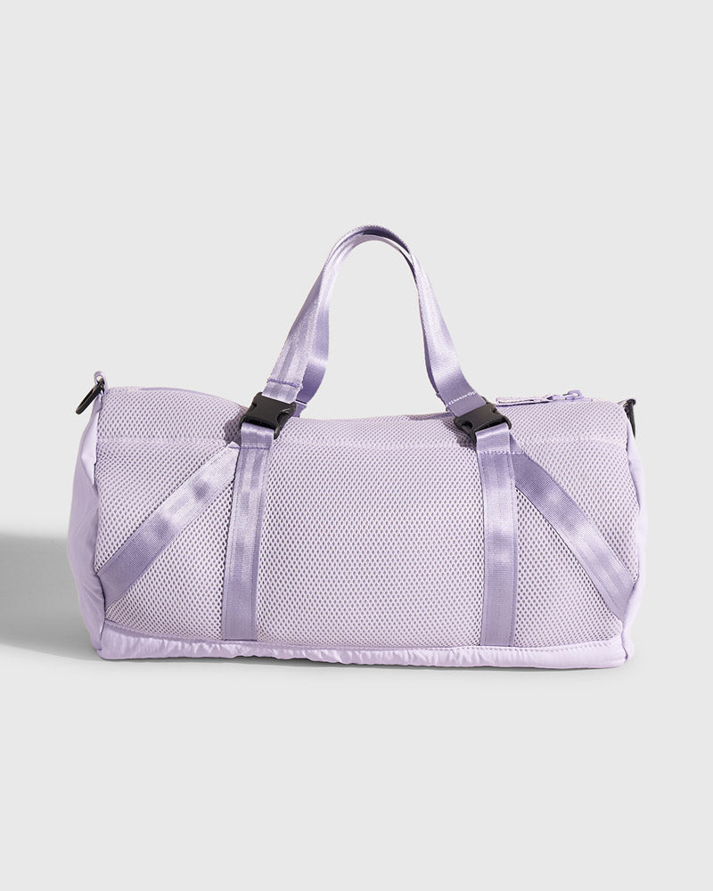 Lavender (Re)active™ 16L Mini Duffle (Angle): Light purple mesh duffle bag with satin straps and black buckles