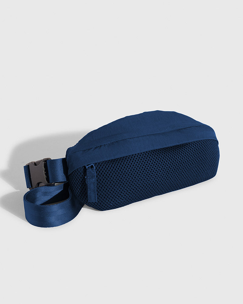 Blueberry (Re)active™ 1L Fanny Pack (Angle): Navy blue fanny pack with mesh front panel and buckle strap