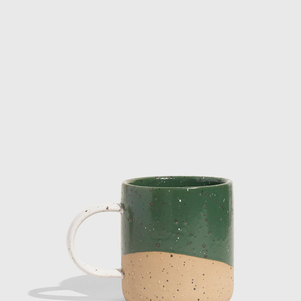 Pine 8 oz. Stoneware Mug (Angle): Dark green glazed upper half, unglazed speckled tan lower half, white handle